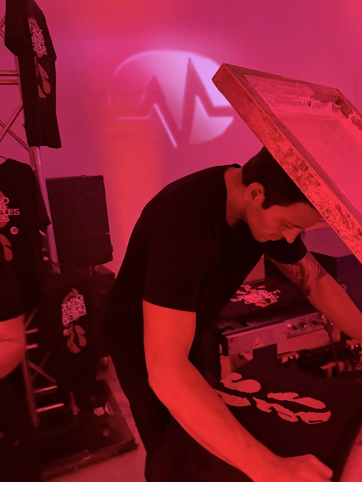 Guests watching custom merch get printed live at a Phoenix event
